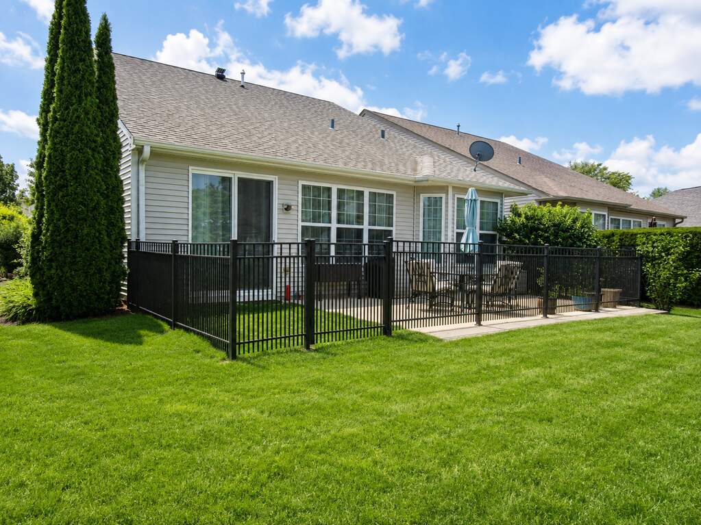 Fenced backyard with concrete patio behind the ranch