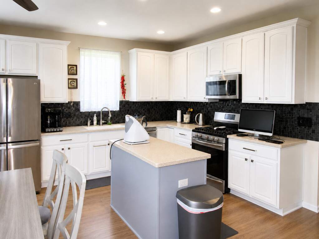 Updated white kitchen with soft-close cabinetry and stainless appliances